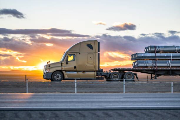 Semi truck on highway at sunset